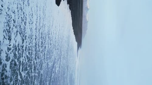 Vertical Video Aerial View of Arctic Black Sand Beach