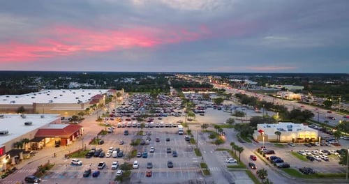 Aerial View of Shopping Plaza Stores and American Wide Highway with Many Driving Cars in North Port