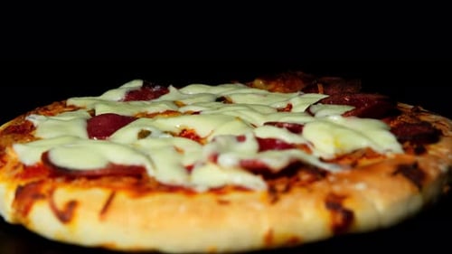 Pizza with Melted Cheese and Sausage close-up