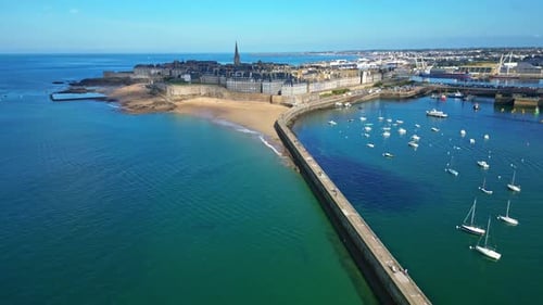 Môle des Noires pier with Saint-Malo in background, Brittany in France. Aerial backward, panoramic