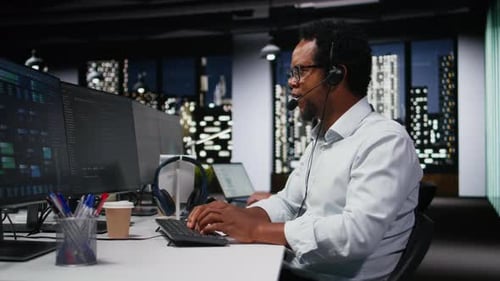 Startup Helpdesk System Administrator in Office Speaking in Headset Mic