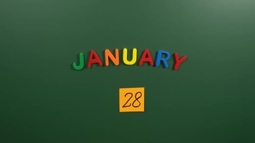 Hand sticking a sticker 28 January calendar day on school board. 28 date of January. Twenty eighth