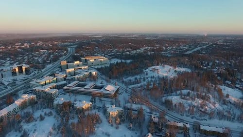 Snowy Cityscape at Sunrise Aerial View