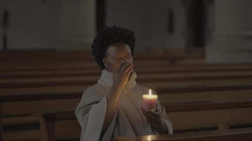 Young African Woman With Curly Hair Praying Inside Church