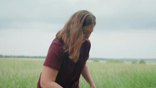 Woman Readying Spray Before Walk Ensuring Safety with Spray During Outdoor Trek Calm Woman in Maroon