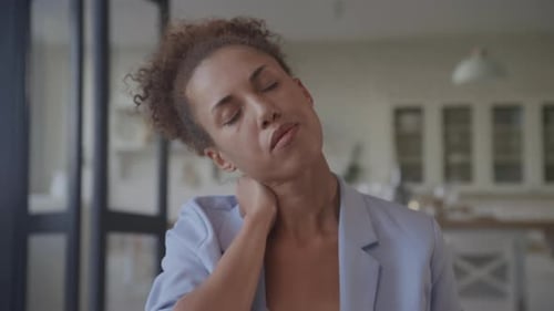 Woman Stretching Neck in Home Office