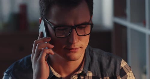 A Young Professional Engages in a Phone Call in a Sleek Modern Home Office with Style