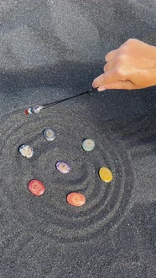 Pendulum Reading Stones on Black Sand Beach