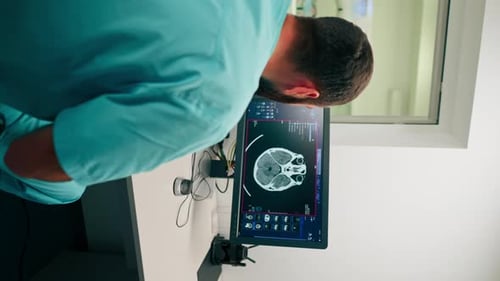 Medical Professional Examines Skull Scan in Hospital Room