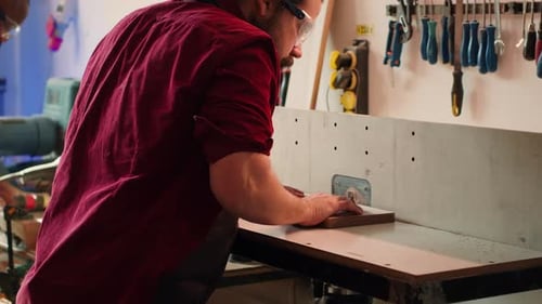 Man Shaping Wood in Workshop with Safety Glasses