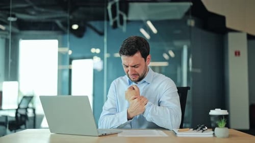 Tired Corporate Employee Touching Aching Wrist Because of Severe Joint Strain