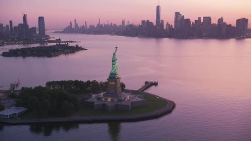New York City, Fly by Statue of Liberty on approach to Manhattan in early morning.