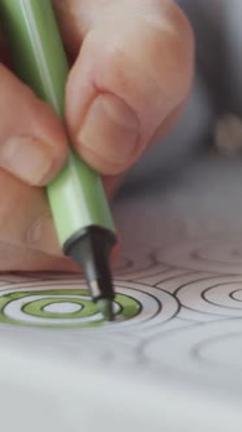 Adult colors coloring book with green marker