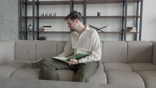 Focused Businessman Writes Down Important Points