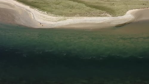 Aerial View of Tranquil Beach Meeting the Ocean
