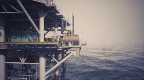 Oil Rig Platform Standing Tall Over Calm Ocean Waters During Daylight Hours