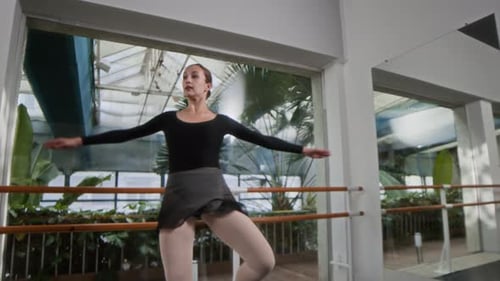 Graceful Woman Performing Ballet Dance in Spacious Studio