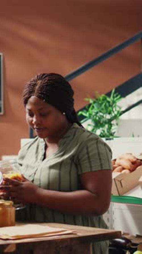Woman Packing Colorful Pickles in Small Business