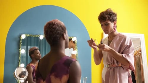 Adult Applies Makeup in Dressing Room