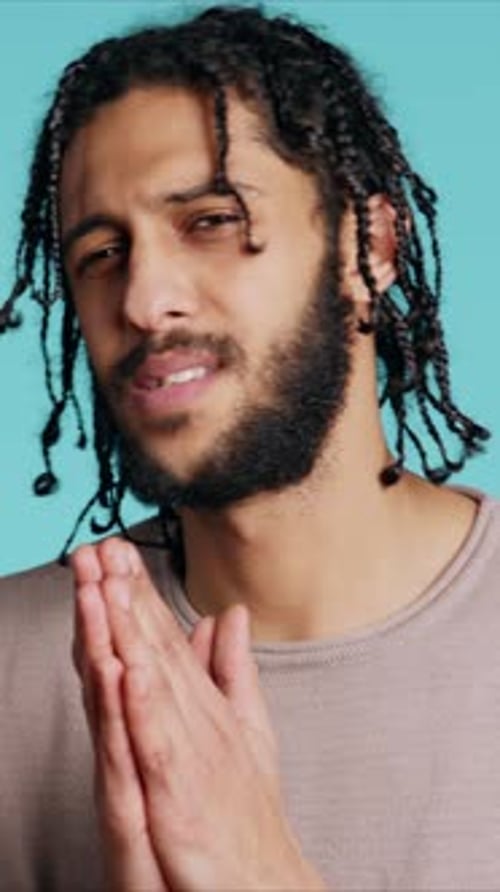 Young Adult Man with Braids Gesturing and Talking
