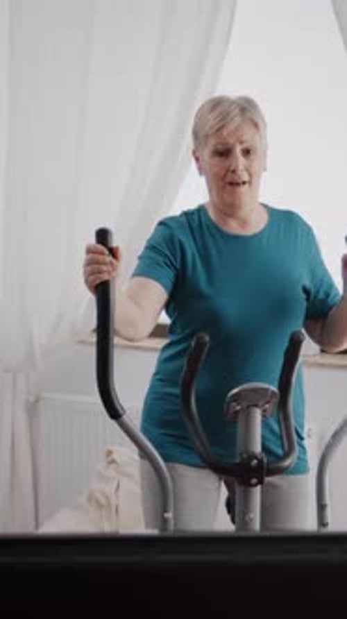 Senior Woman Uses Elliptical Exercise Machine