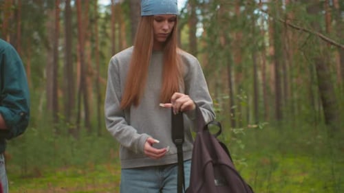 Tired Hikers Walk Through Peaceful Forest Preparing to Rest