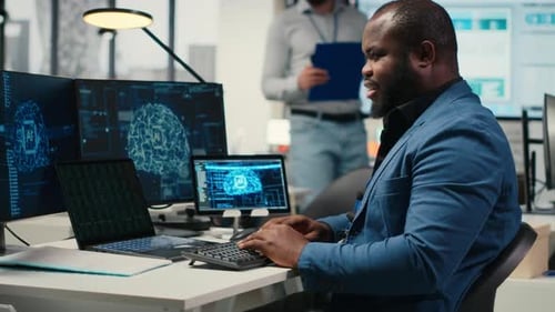 Man Types at Desk with AI Displays in Modern Office