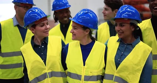 Multiracial Engineers Working Inside Robotic Factory African