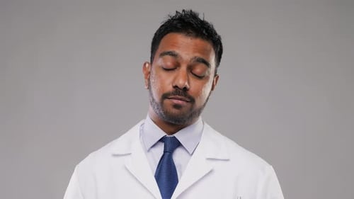 Medical Professional Talking Against a Plain Background