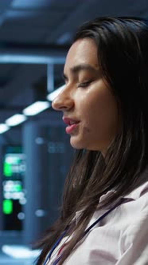 Vertical Video Programmer in Data Center Typing on Computer Keyboard