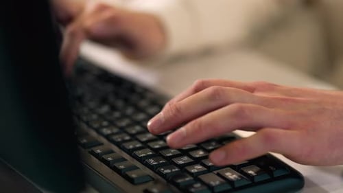 Hands Typing on a Computer Keyboard at Work