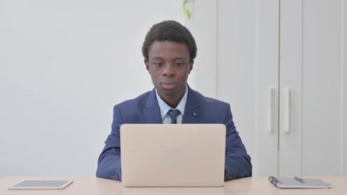 Young African Businessman Reacting to Loss in Office