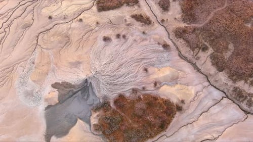 Aerial view of mud volcanoes and cracked earth at Vulcanii Noroiosi, Romania.