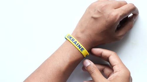 Hand with Blue and Yellow Wristband Colors of Flag of Ukraine