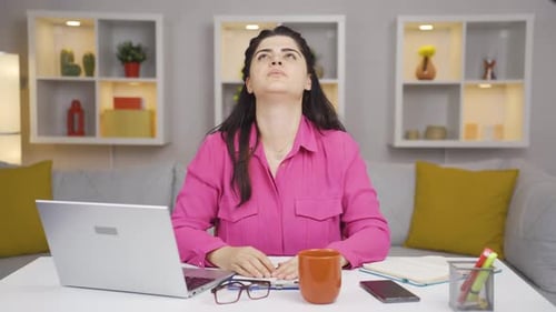 Home office worker woman looking annoyed at camera.