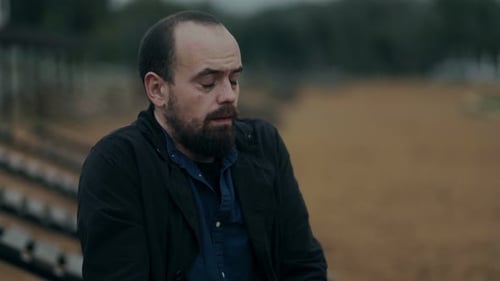 Introspective Man Stands Alone Feeling Hopeless and Distant