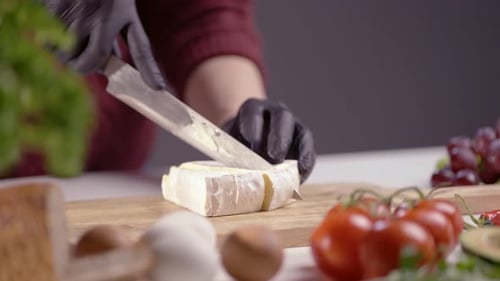 Close-Up of Brie Cheese Slicing on Wooden Board