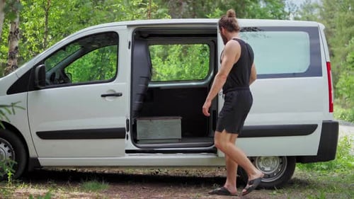 Man Passes By And Close The Door Of A White Van - static shot