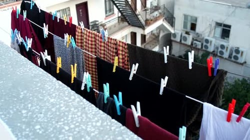 Garments drying on clothesline in an urban setting