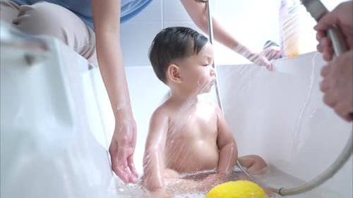 Child Bathed in Tub with Parental Assistance