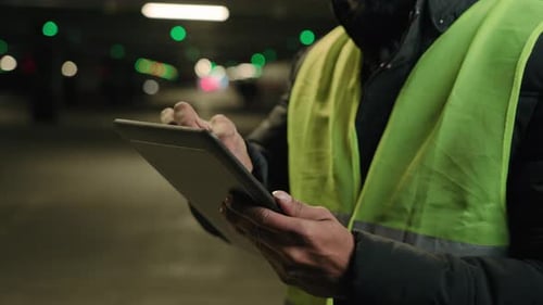 Closeup Male Hands Hold Digital Tablet Unknown Man Builder in Safety Uniform Unrecognizable Industry