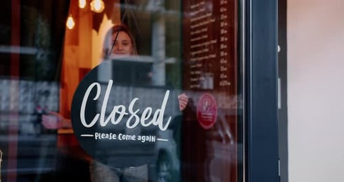 Happy Young Waitress Opening Restaurant