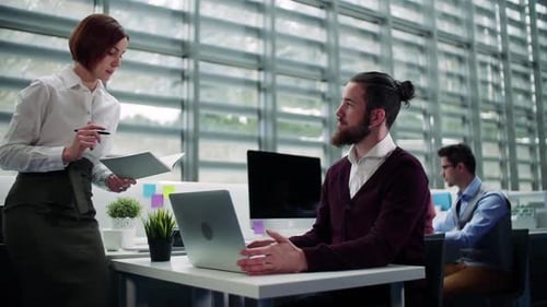 Group of Young Businesspeople Working Together in Office, Talking