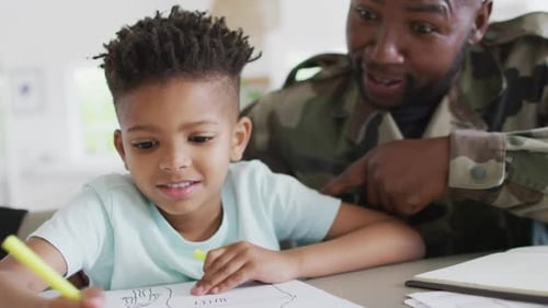 Boy Drawing with Father in Military Camouflage Jacket