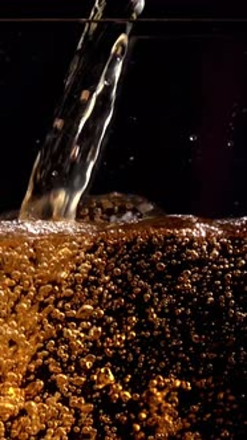 Bubbles Forming Inside a Dark Beverage, Vertical Video