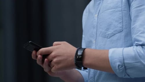 Man using smart phone outside in urban environment