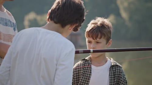 Fisherman Shows Schoolboys Components of Fishing Rod
