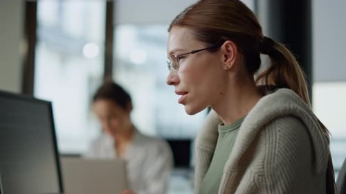 Woman Reviews Computer Code at Office Workplace