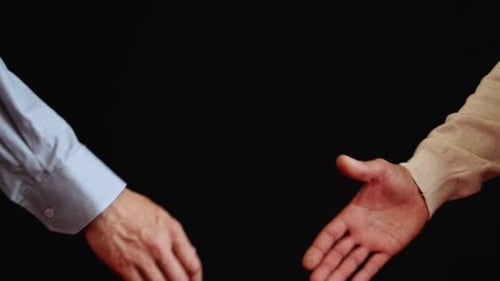 Close Up of a Handshake on Black Background