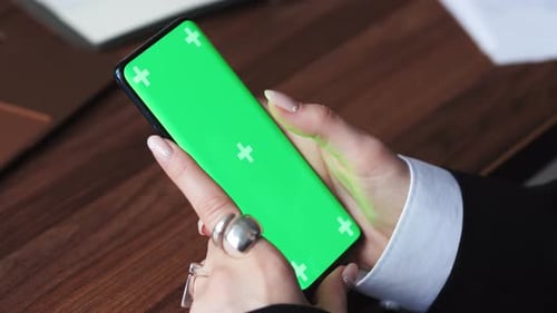 Women Using Smartphone with Green Background Scrolling on Mobile Phone Green Screen Closeup on Hands